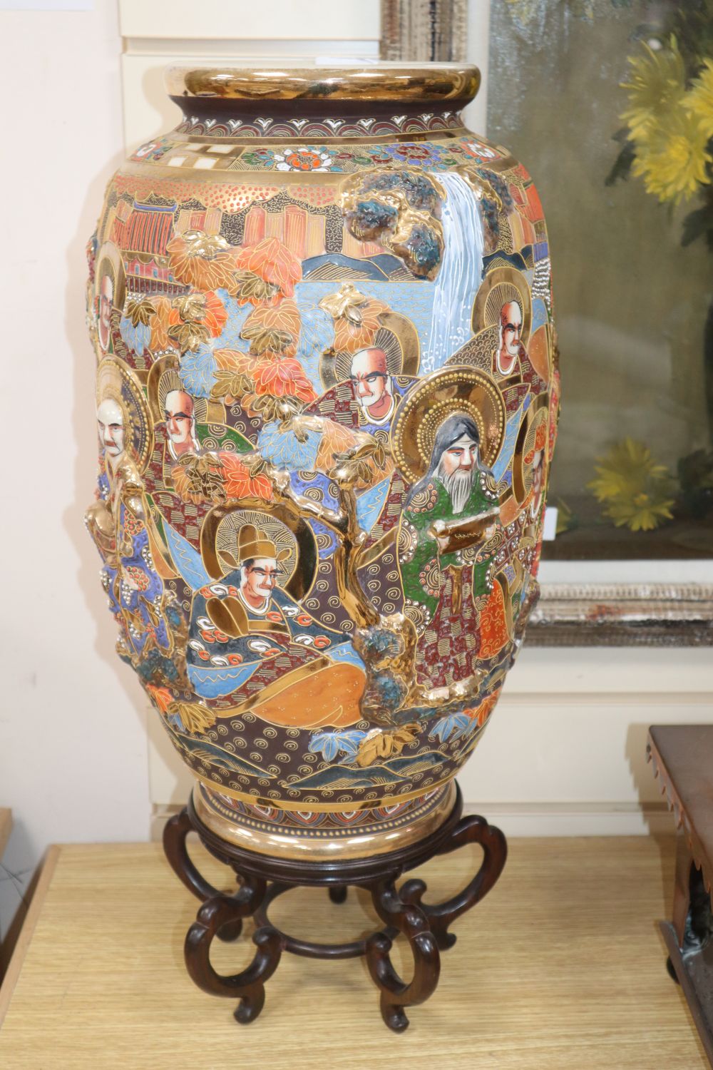 An early 20th century Japanese Satsuma ovoid pottery vase, 46cm, on hardwood stand